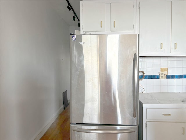 24-65 38th St Unit D10, Astoria, NY 11103 - kitchen with freestanding refrigerator, backsplash, white cabinets, and light countertops
