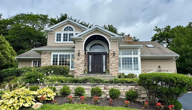 10 Hazelwood Ct, Jericho, NY 11753 - craftsman-style home featuring stone siding, a chimney, and roof with shingles