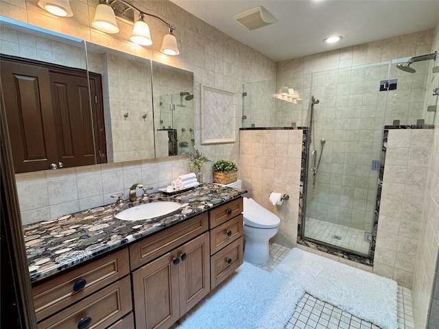 10 Hazelwood Ct, Jericho, NY 11753 - bathroom with vanity, tile walls, a shower stall, tasteful backsplash, and tile patterned flooring