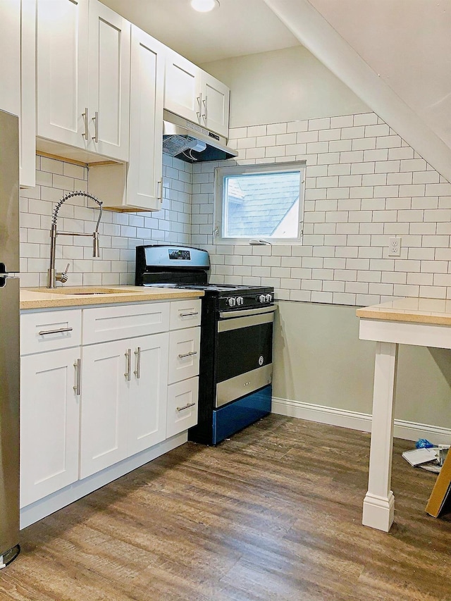 114 Park Ave, Mount Vernon, NY 10550 - kitchen with stainless steel electric range oven, under cabinet range hood, dark wood-style flooring, and white cabinets