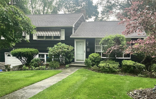 57 Central Ave, Tappan, NY 10983 - split level home with roof with shingles, a front yard, and a chimney