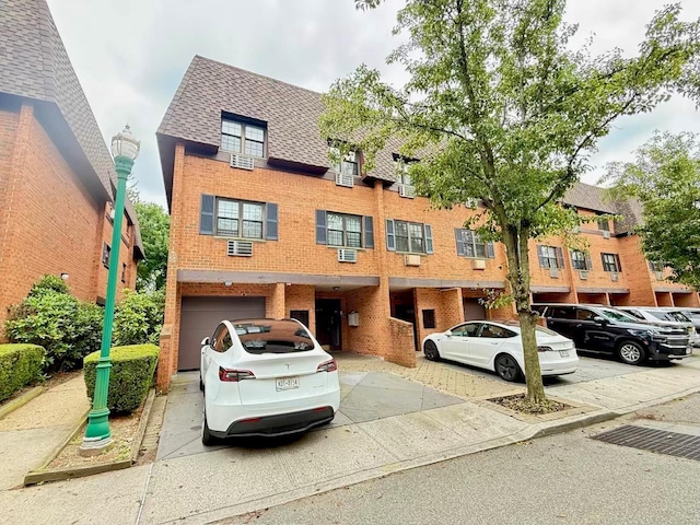 22035 67th Ave Unit C, Bayside, NY 11364 - view of front of house featuring brick siding, a shingled roof, a garage, and concrete driveway