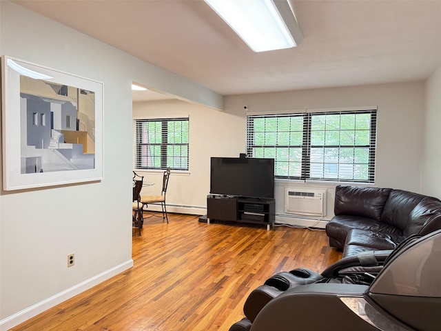 22035 67th Ave Unit C, Bayside, NY 11364 - living area with light wood finished floors, a wall unit AC, and a baseboard radiator
