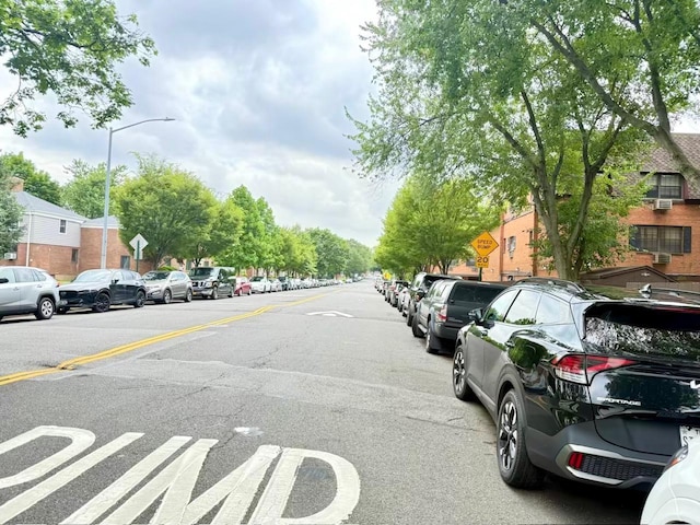 22035 67th Ave Unit C, Bayside, NY 11364 - view of asphalt street with traffic signs, street lighting, and a residential view