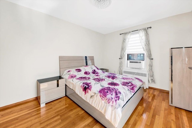 2615 Homecrest Ave Unit 1D, Brooklyn, NY 11235 - bedroom with radiator heating unit and wood finished floors