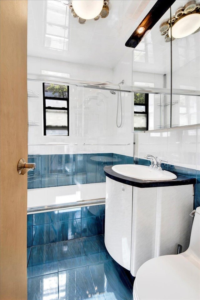2615 Homecrest Ave Unit 1D, Brooklyn, NY 11235 - full bathroom with marble look tiles, plenty of natural light, vanity, and tiled shower / bath