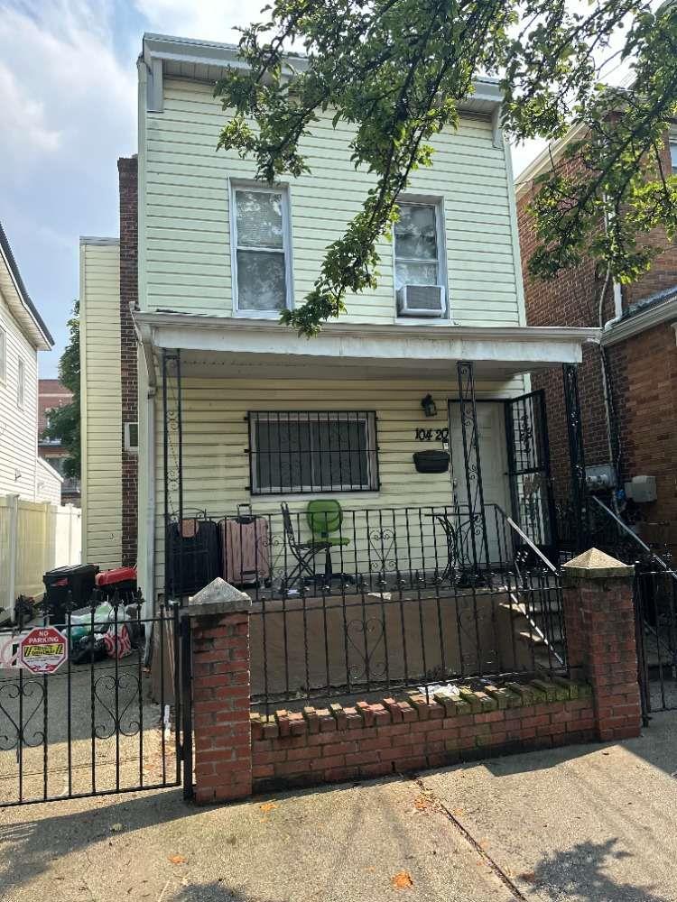 104-20 47th Ave, Corona, NY 11368 - view of front of home featuring a porch, a fenced front yard, a gate, and cooling unit