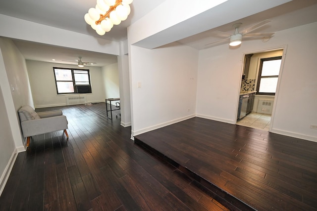 84-01 Main St Unit 410, Briarwood, NY 11435 - unfurnished living room featuring ceiling fan, wood-type flooring, and radiator