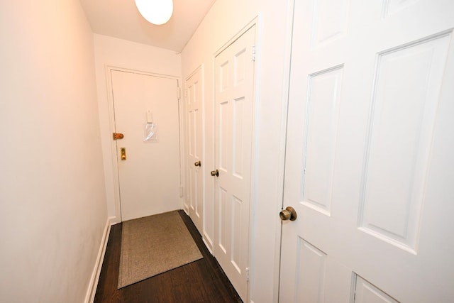 84-01 Main St Unit 410, Briarwood, NY 11435 - doorway to outside featuring dark wood-style floors and baseboards