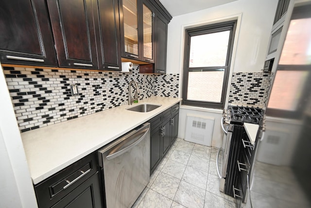84-01 Main St Unit 410, Briarwood, NY 11435 - kitchen featuring stainless steel appliances, light marble finish flooring, light countertops, decorative backsplash, and glass insert cabinets