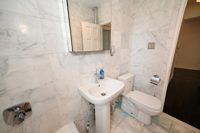 84-01 Main St Unit 410, Briarwood, NY 11435 - bathroom featuring tile walls and toilet