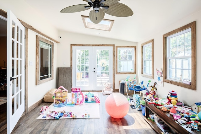 59 Acre Ln, Hicksville, NY 11801 - game room featuring french doors, a ceiling fan, lofted ceiling, wood finished floors, and a skylight