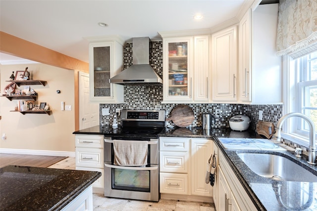 59 Acre Ln, Hicksville, NY 11801 - kitchen with wall chimney exhaust hood, range with two ovens, decorative backsplash, and dark stone counters