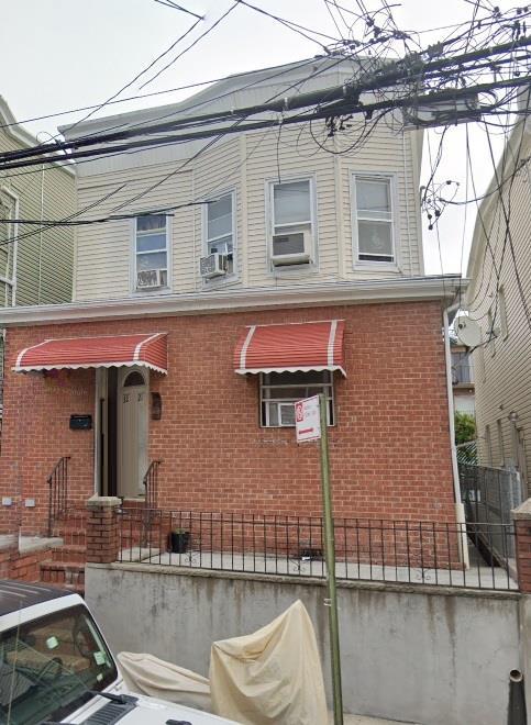 32-21 106th St, East Elmhurst, NY 11369 - view of side of home featuring brick siding and cooling unit