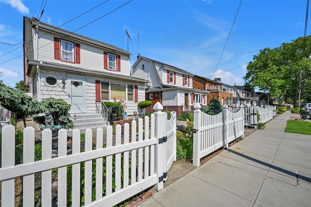 92-05 218th Pl, Queens Village, NY 11428 - traditional-style home featuring a fenced front yard, a residential view, and a gate