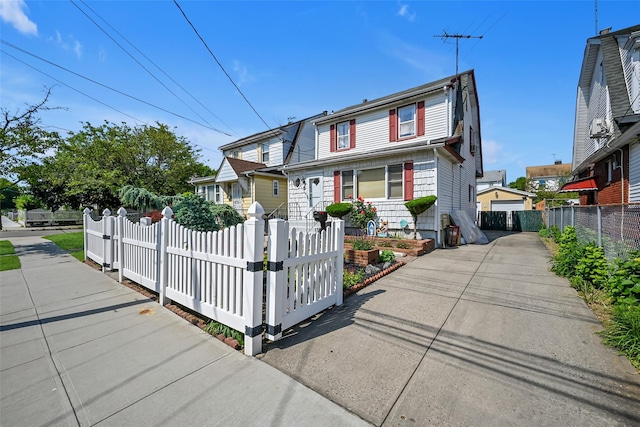 92-05 218th Pl, Queens Village, NY 11428 - view of front facade with a fenced front yard and a gate