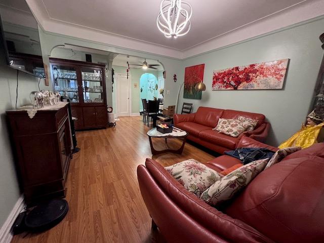 3545 81st St Unit C2, Jackson Heights, NY 11372 - living room with light wood-style flooring, a chandelier, and a ceiling fan