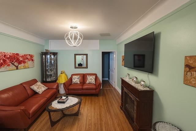 3545 81st St Unit C2, Jackson Heights, NY 11372 - living room featuring a chandelier and wood finished floors
