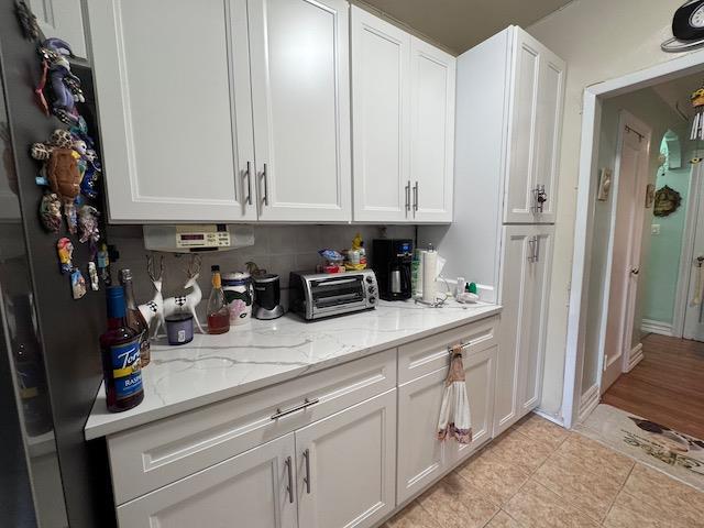 3545 81st St Unit C2, Jackson Heights, NY 11372 - kitchen with white cabinetry and light stone counters