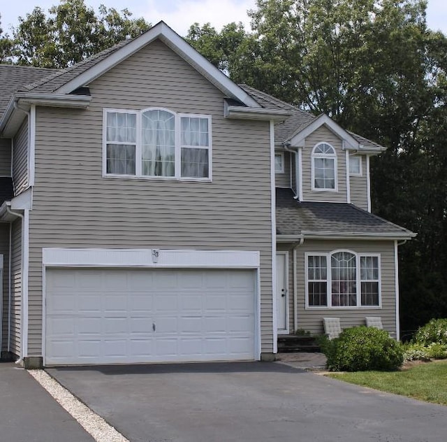 33 Sunflower Ridge Rd, South Setauket, NY 11720 - traditional-style home featuring driveway, an attached garage, and roof with shingles