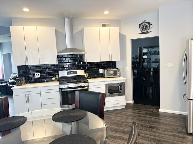 33 Sunflower Ridge Rd, South Setauket, NY 11720 - kitchen featuring stainless steel appliances, wall chimney range hood, dark wood-style flooring, light countertops, and recessed lighting