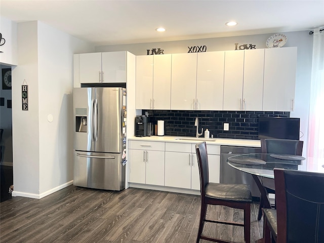 33 Sunflower Ridge Rd, South Setauket, NY 11720 - kitchen with appliances with stainless steel finishes, dark wood finished floors, light countertops, decorative backsplash, and recessed lighting