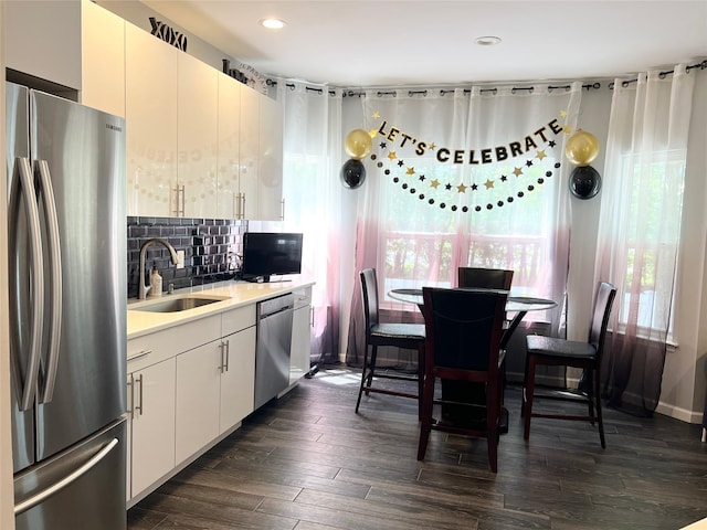 33 Sunflower Ridge Rd, South Setauket, NY 11720 - kitchen featuring stainless steel appliances, light countertops, decorative backsplash, dark wood finished floors, and recessed lighting