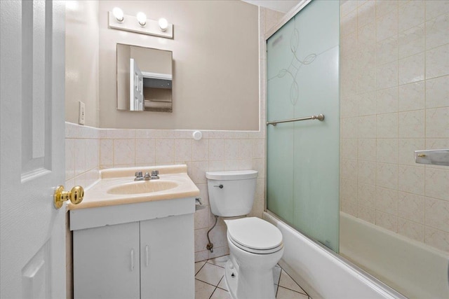 1935 Holland Ave, Bronx, NY 10462 - full bath featuring vanity, tile walls, bath / shower combo with glass door, tile patterned flooring, and wainscoting