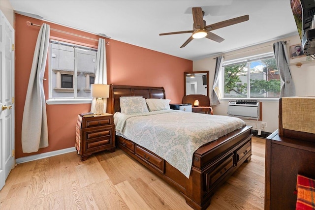 1935 Holland Ave, Bronx, NY 10462 - bedroom featuring light wood-style flooring, a wall unit AC, and ceiling fan