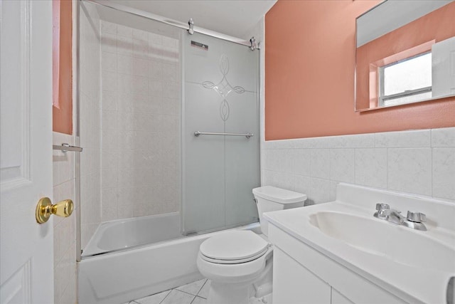 1935 Holland Ave, Bronx, NY 10462 - full bath featuring tile walls, vanity, shower / bath combination with glass door, wainscoting, and tile patterned floors
