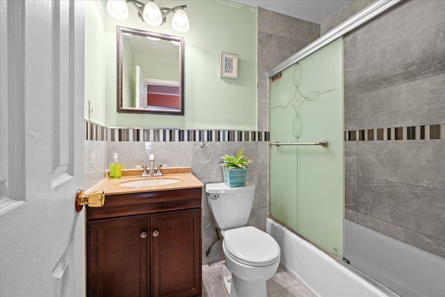 1935 Holland Ave, Bronx, NY 10462 - full bathroom with vanity, bath / shower combo with glass door, tile walls, and wainscoting