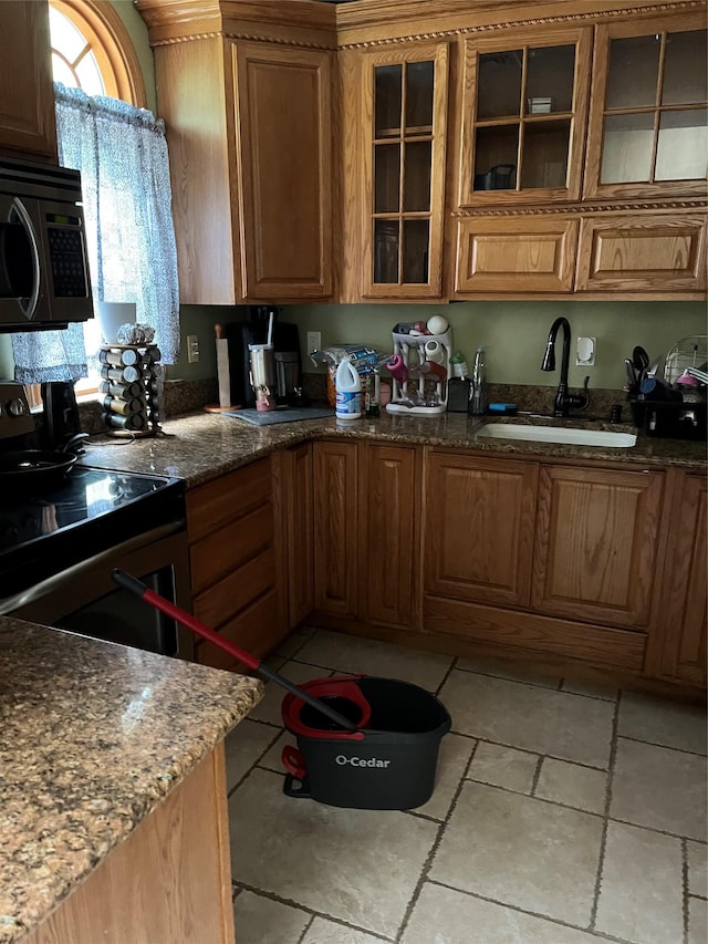 11 Amesworth Ct, Middle Island, NY 11953 - kitchen featuring stainless steel microwave, stone counters, glass insert cabinets, and brown cabinets