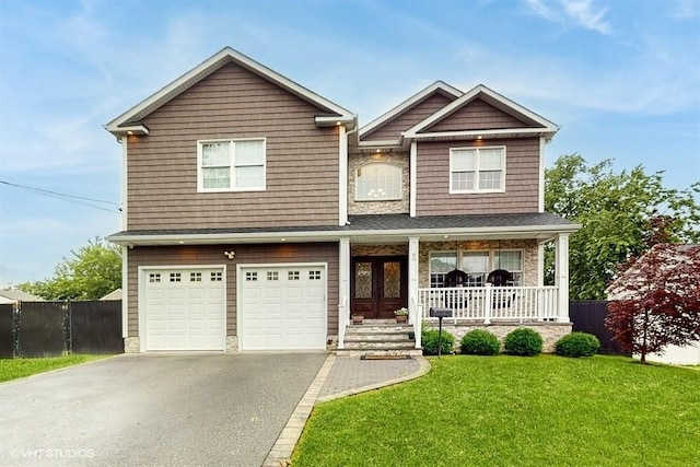 60 E Minerva Rd, Lindenhurst, NY 11757 - view of front of property featuring covered porch, driveway, an attached garage, and stone siding