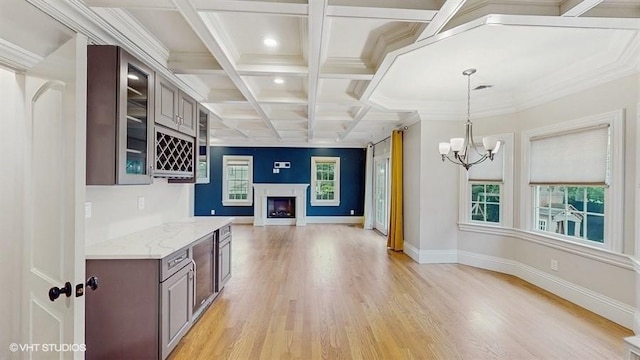 60 E Minerva Rd, Lindenhurst, NY 11757 - kitchen with light wood finished floors, coffered ceiling, glass insert cabinets, beam ceiling, and a fireplace