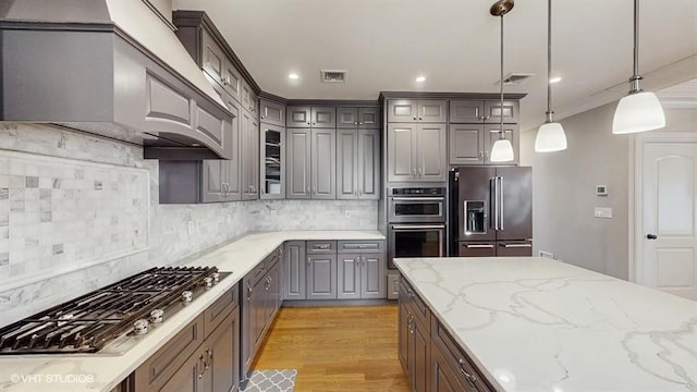 60 E Minerva Rd, Lindenhurst, NY 11757 - kitchen with stainless steel appliances, gray cabinetry, custom range hood, backsplash, and crown molding