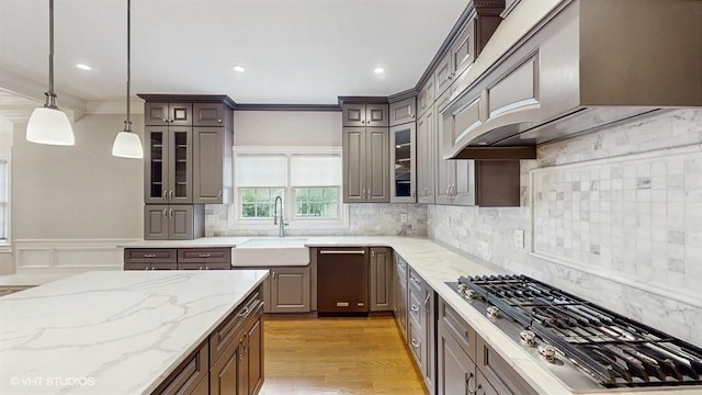 60 E Minerva Rd, Lindenhurst, NY 11757 - kitchen with stainless steel gas cooktop, crown molding, glass insert cabinets, pendant lighting, and decorative backsplash