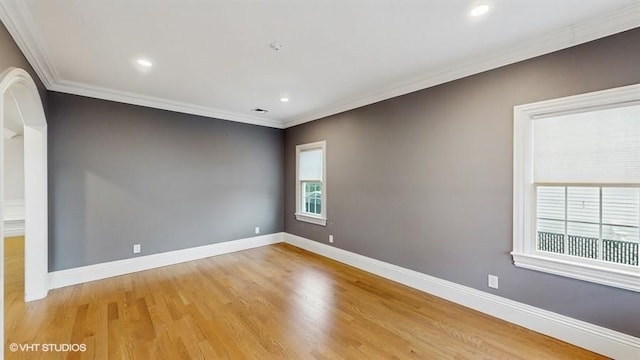 60 E Minerva Rd, Lindenhurst, NY 11757 - spare room with light wood finished floors, crown molding, recessed lighting, and arched walkways