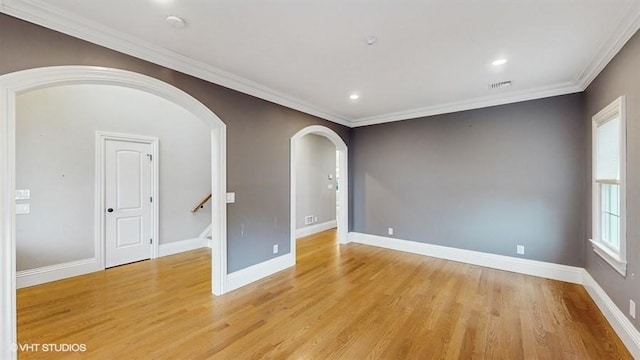 60 E Minerva Rd, Lindenhurst, NY 11757 - empty room with arched walkways, light wood-type flooring, crown molding, a smoke detector, and recessed lighting