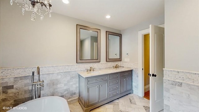 60 E Minerva Rd, Lindenhurst, NY 11757 - bathroom with tile walls, a wainscoted wall, double vanity, a freestanding tub, and recessed lighting
