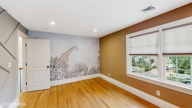 60 E Minerva Rd, Lindenhurst, NY 11757 - spare room with light wood-style floors, healthy amount of natural light, recessed lighting, and stairs