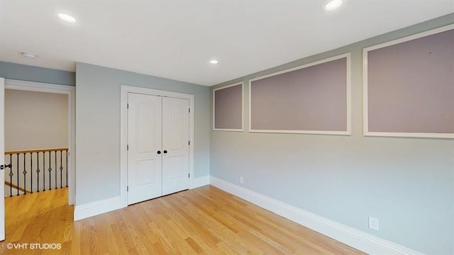 60 E Minerva Rd, Lindenhurst, NY 11757 - unfurnished bedroom featuring light wood-type flooring, a closet, and recessed lighting