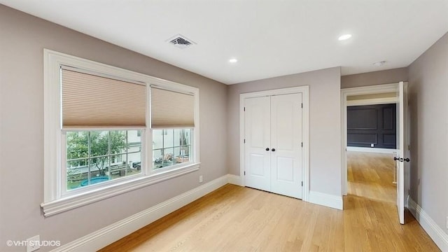 60 E Minerva Rd, Lindenhurst, NY 11757 - unfurnished bedroom with light wood-style flooring, a closet, and recessed lighting