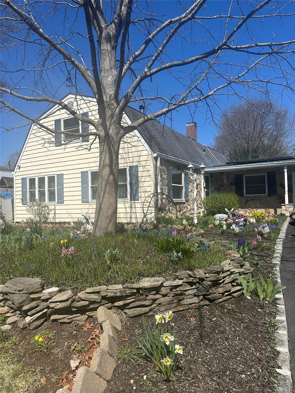 4 Bridle Path, Farmingville, NY 11738 - view of front of house with a chimney and stone siding