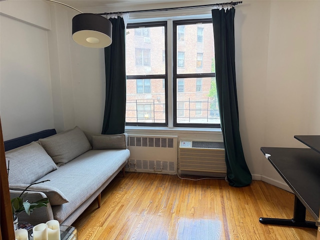 100-25 Queens Blvd Unit 3D, Forest Hills, NY 11375 - living area featuring radiator, plenty of natural light, and light wood-style flooring
