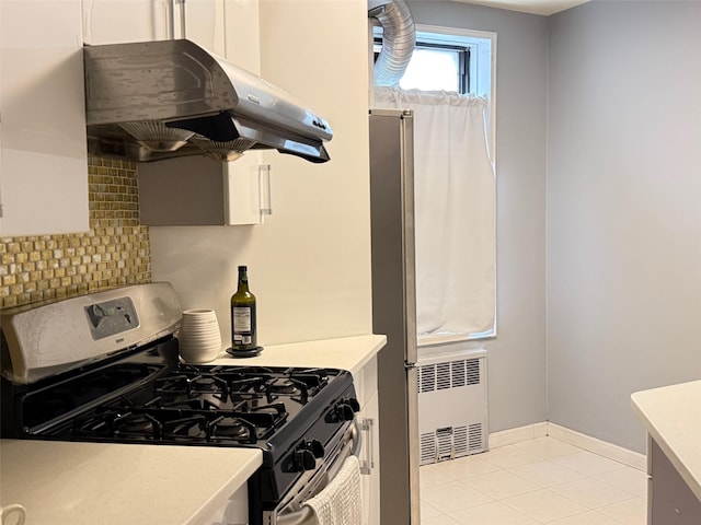 100-25 Queens Blvd Unit 3D, Forest Hills, NY 11375 - kitchen featuring appliances with stainless steel finishes, under cabinet range hood, radiator, and light countertops