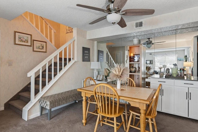 216UNITM Springmeadow Dr, Holbrook, NY 11741 - dining space with ceiling fan, stairs, a textured ceiling, and dark colored carpet