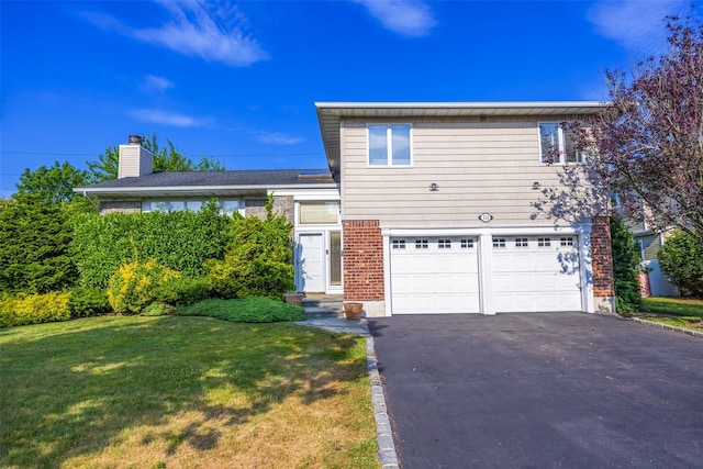 18 Sutton Ter, Jericho, NY 11753 - view of front of property featuring a garage, asphalt driveway, a front yard, a chimney, and brick siding