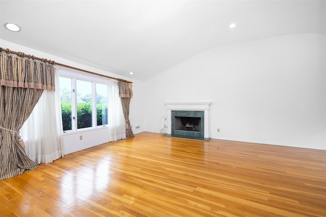 18 Sutton Ter, Jericho, NY 11753 - unfurnished living room with vaulted ceiling, light wood-style floors, a high end fireplace, and recessed lighting