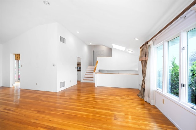 18 Sutton Ter, Jericho, NY 11753 - unfurnished living room featuring vaulted ceiling, light wood-type flooring, a skylight, and recessed lighting