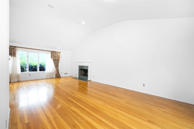 18 Sutton Ter, Jericho, NY 11753 - unfurnished living room with vaulted ceiling, a premium fireplace, and light wood-type flooring